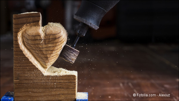 Sanding wood in heart shape with a rotary tool